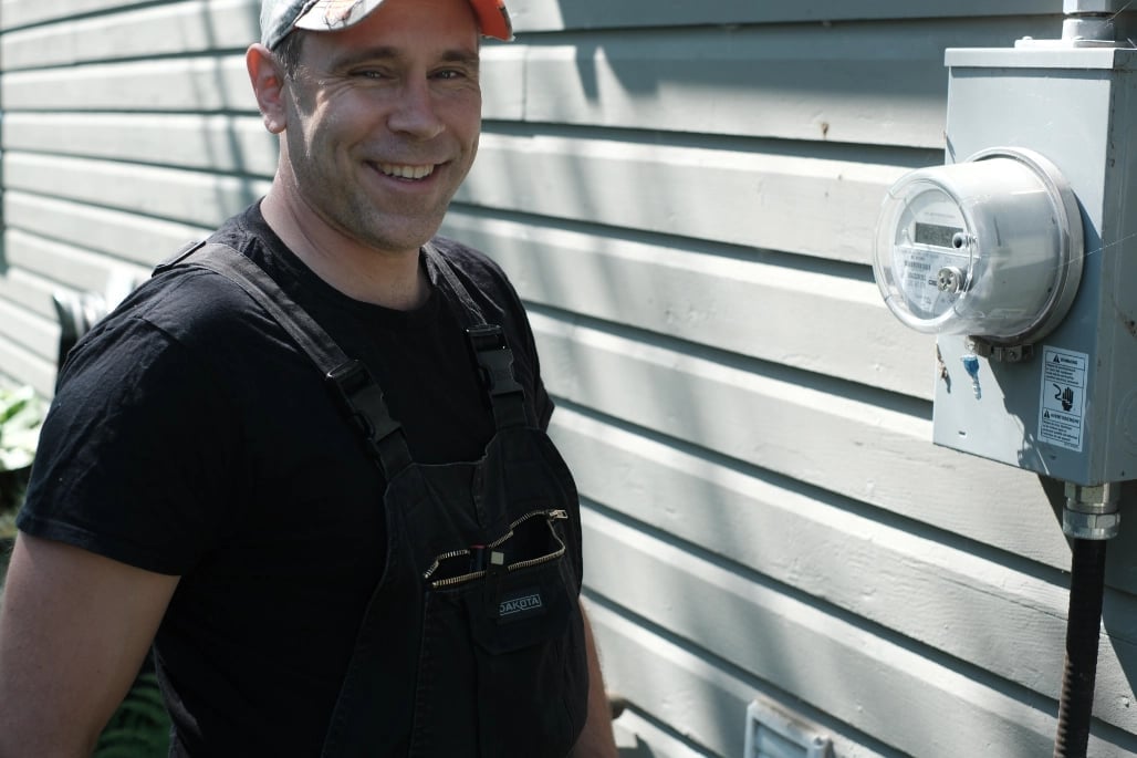 Professional electrician in safety vest inspecting electrical meter — CN Electrical serving Chilliwack homes and businesses